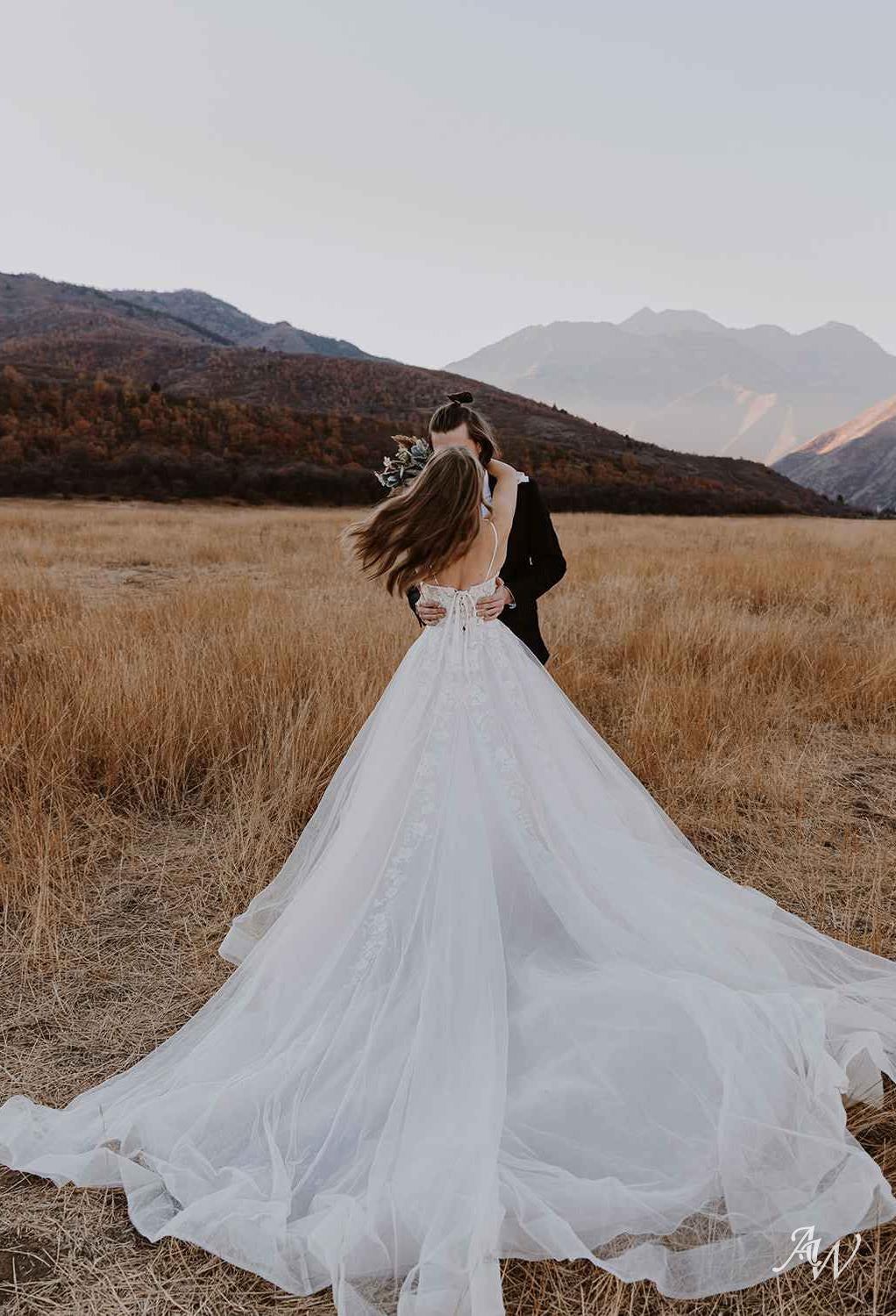 a woman in a white dress is flying a kite