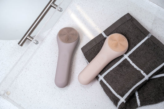 a hair brush and a towel on a bathroom floor