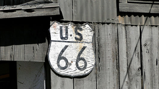 A sign on the side of a wooden building