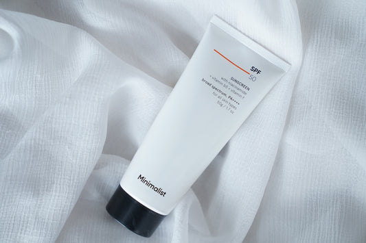 A tube of cream sitting on top of a white sheet