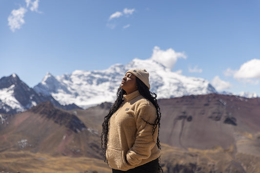 A woman standing on top of a mountain