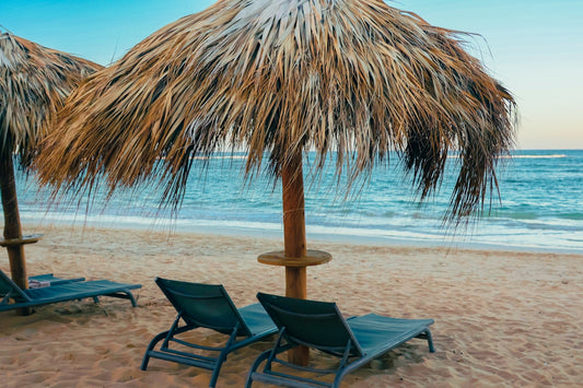 Tropical beach with umbrellas and lounge chairs.