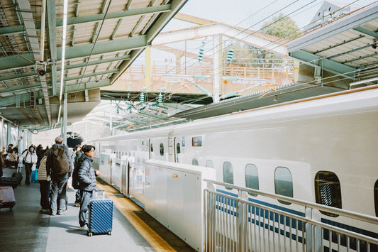 People are boarding a train at a station.