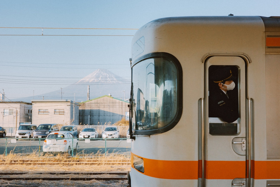A train driver looks out at mount fuji.