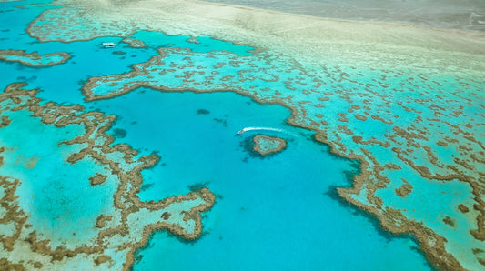 An aerial view of Heart Reef and turquoise coral formations in the Great Barrier Reef