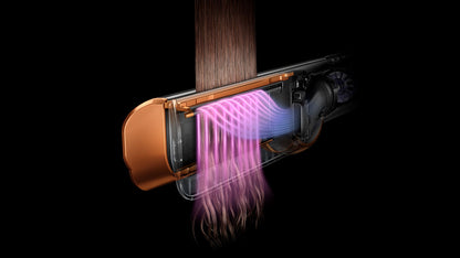 a woman in a pink dress holding a cell phone 