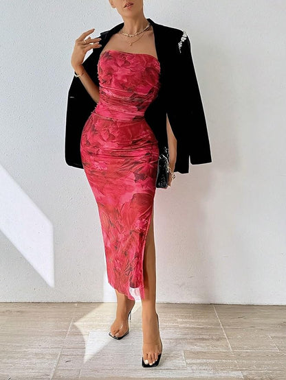 a woman in a pink dress standing in front of a wall 