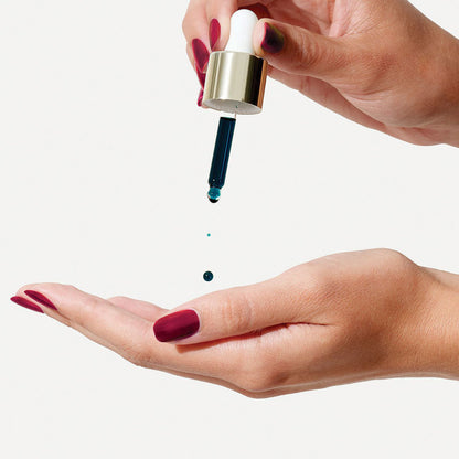 a person holding a toothbrush in their hand 