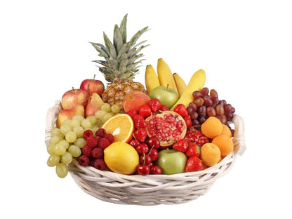 a bowl filled with fruit on top of a table 