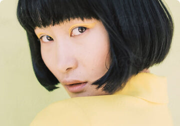 a woman wearing a hat and a tie 