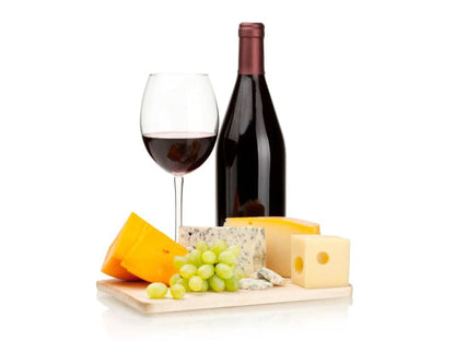 a glass of wine and a plate of food on a table 