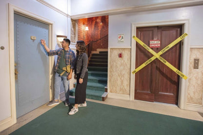a group of people standing in front of a building 
