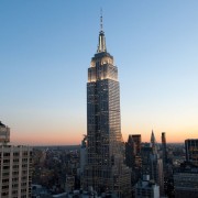 a very tall clock tower towering over a city 